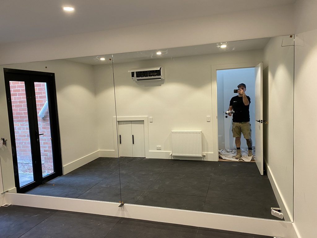 Large wall mirrors in home gym area